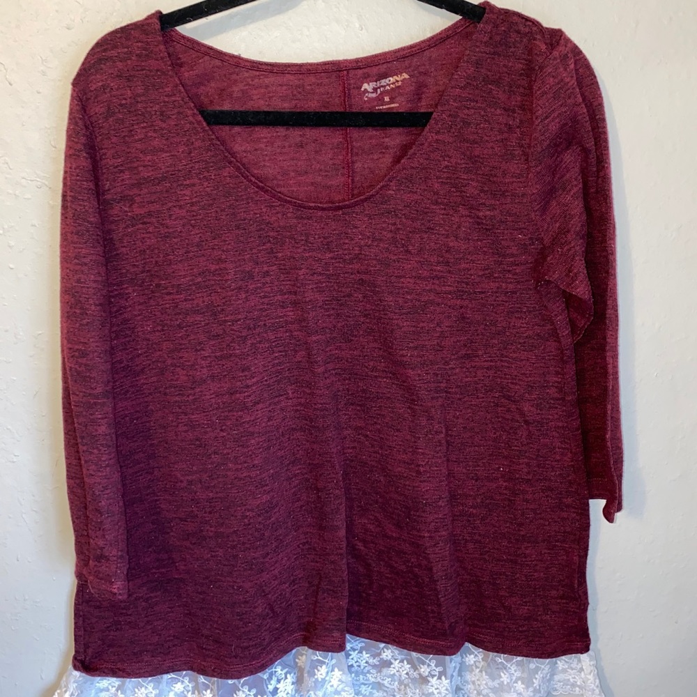 Long sleeve sweater with lace on the bottom.
